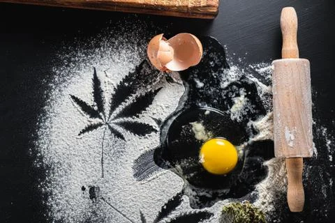 The process of making cannabis pastries. raw broken egg, a rolling pin, flour 스톡 사진