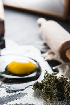 The process of making cannabis pastries. raw broken egg, a rolling pin, flour 스톡 사진