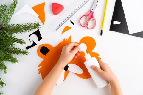 The process of making a children's New Year tiger mask with a child made of c Stock Photos