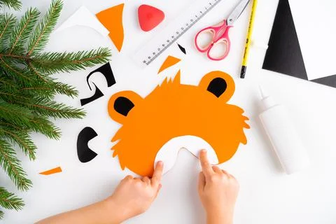 The process of making a children's New Year tiger mask with a child made of c Stock Photos