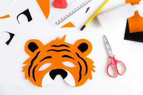 The process of making a children's New Year tiger mask with a child made of Stock Photos