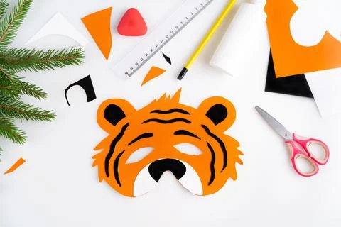 The process of making a children's New Year tiger mask with a child made of Stock Photos