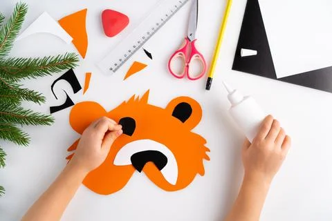 The process of making a children's New Year tiger mask with a child made of Stock Photos