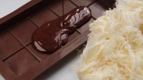 Process of making chocolate bars filled with Turkish sweets pismaniye, pouring Stock Footage 303782558