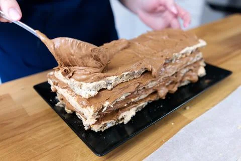 The process of making a chocolate cake with nuts and cream. Stock Photos