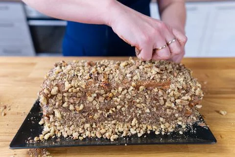 The process of making a chocolate cake with nuts and cream. Stock Photos