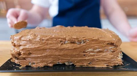 The process of making a chocolate cake with nuts and cream. Stock Photos