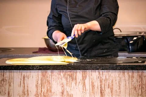 The process of making chocolate in a chocolate studio. Bitter chocolate with  Stock Photos