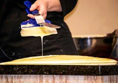 The process of making chocolate in a chocolate studio. Bitter chocolate with  Stock Photos