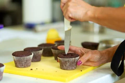 The process of making chocolate cupcakes with sweet cream. Creation of cakes  Stock Photos