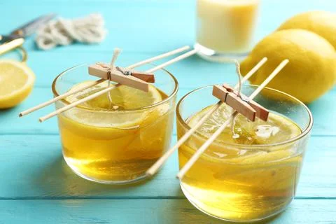Process of making citrus candles on table Stock Photos
