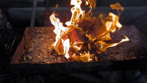 The process of making coals for grilled fish, made from old coconut shells Stock Photos