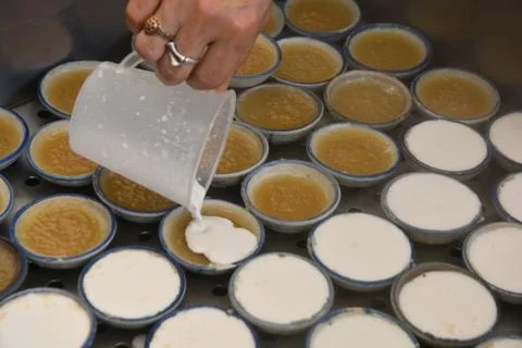 Process of making coconut milk custard in small porcelain cup Stock Photos
