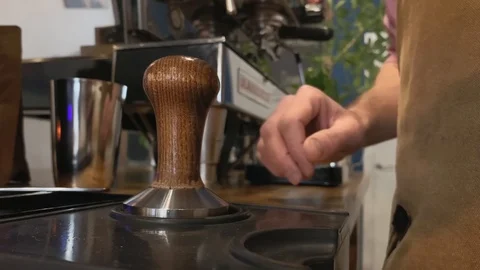 The process of making coffee. Closeup of hand holding a portafilter with ground Stock Footage 123553234