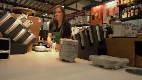 The process of making coffee in a coffee shop and delivering it to a client.  Stock Footage 220227272