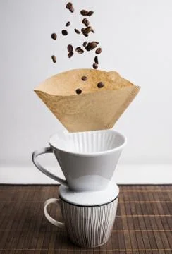 Process of making coffee with flying cups, beans and filter. Magic coffeemaking. Stock Photos