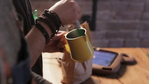 Process of making coffee or cocoa drink. Professional barista is mixing Stock Footage 126853188