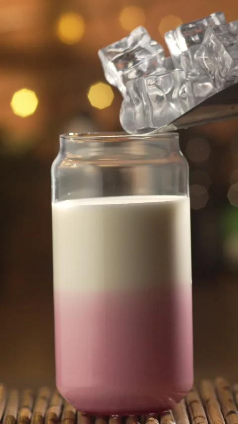 Process of making cold cherry latte. Professional barista dropping ice cube.. Stock Footage 340069024