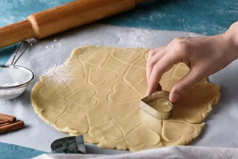 Process of making cookie dough heart shape on kitchen blue table Stock Photos