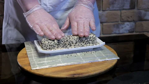 The process of making, cooking, preparing rolls using a sushi Mat. Stock Footage 131508359