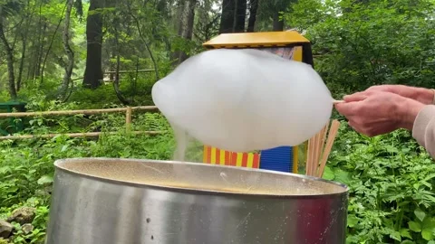 The process of making cotton candy outdoors for children. Stock Footage 249876358
