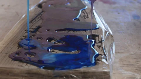 Process making of a craft resin and wood cutting board. Liquid epoxy is poured Stock Footage 206035796