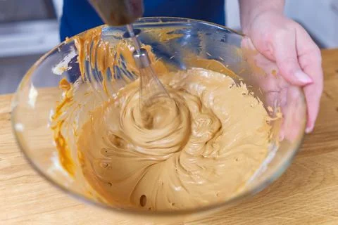 The process of making cream for chocolate cake. Stock Photos