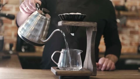 Process of making cup of coffee in V60. Barista at work make strong coffee into Stock Footage 221954984