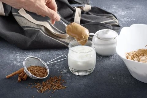 Process of making Dalgona coffee, Korean drink on gray kitchen table, hand pu Stock Photos