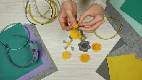 The process of making a decoration on the head. Handmade accessories from felt. Stock Footage 84755212