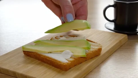 The process of making delicious and flavorful toasts with egg and slices of Stock Footage 308296592