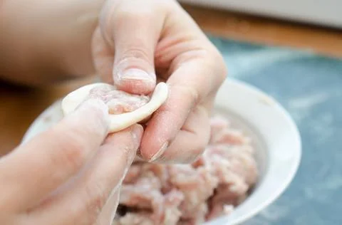 The process of making delicious home-made dumplings with meat. Stock Photos