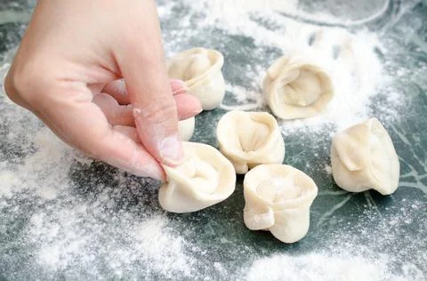 The process of making delicious home-made dumplings with meat. Stock Photos