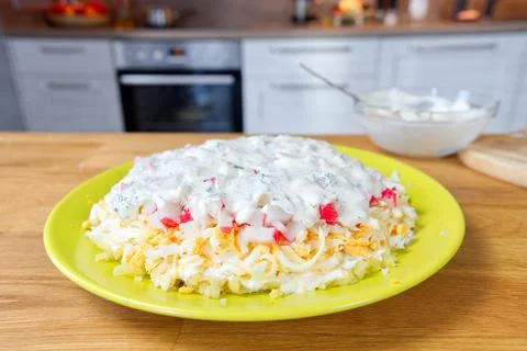 The process of making a delicious salad of crab sticks, carrots, smoked cheese Stock Photos