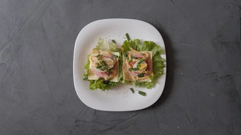 Process of making delicious sandwiches on the white plate. Stock Footage 129428822