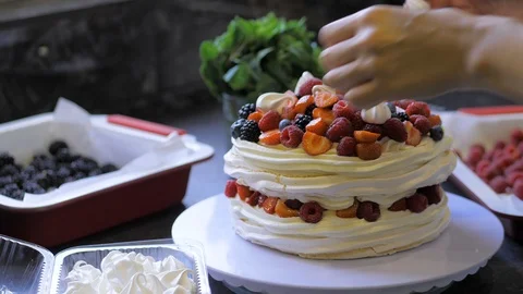 The process of making dessert Anna Pavlova with berries and cream Stock Footage 113744478