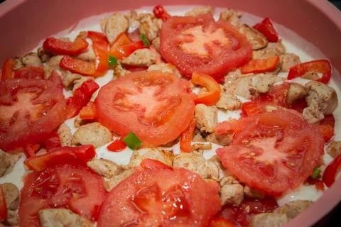 The process of making a diet cake with tomatoes, herbs and chicken. Stock Photos