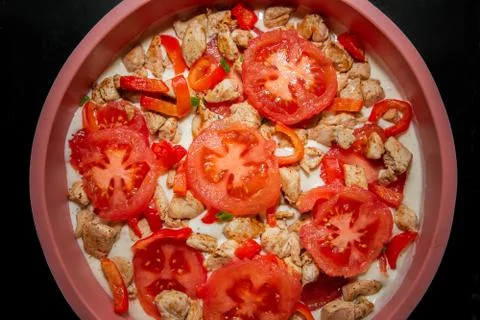 The process of making a diet cake with tomatoes, herbs and chicken. Stock Photos