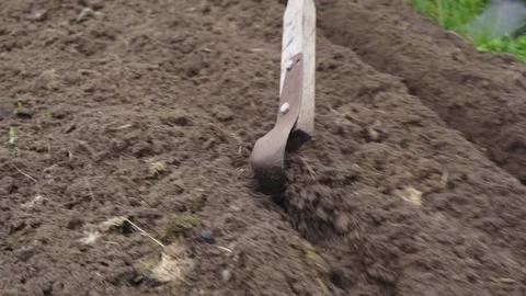 The process of making a ditch with a fokin flat cutter in slow motion Stock Footage 144500146