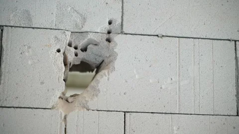 The process of making a doorway in a wall of aerated concrete bricks. A through Stock Footage 232649247