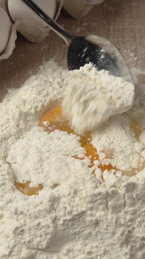 Process of Making dough. Man adding flour into egg in the kitchen Stock Footage 343254035