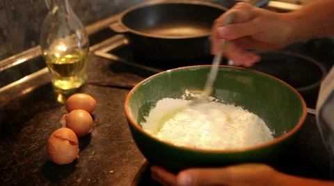 A process of making dough for pancakes: flour being mixed with eggs Stock-Footage 57991084