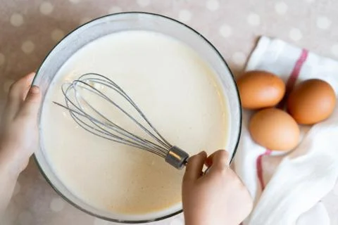 The process of making dough for pancakes with ingredients on a light table Foto stock