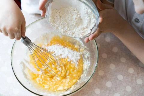 The process of making dough for pancakes with ingredients on a light table Foto stock