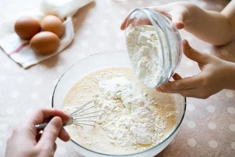 The process of making dough for pancakes with ingredients on a light table Stock Photos
