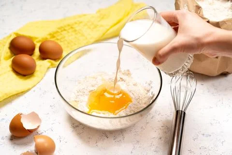 The process of making dough for pancakes with ingredients on a light table, e Foto stock