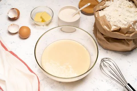 The process of making dough for pancakes with ingredients on a light table, eggs Stock Photos