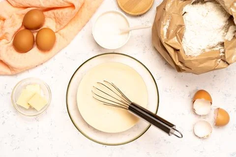 The process of making dough for pancakes with ingredients on a light table, eggs Stock Photos