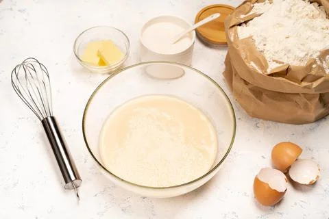 The process of making dough for pancakes with ingredients on a light table, eggs Stock Photos