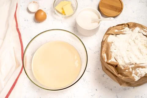 The process of making dough for pancakes with ingredients on a light table, eggs Stock Photos